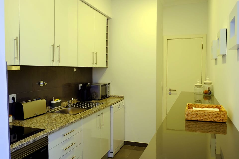 Kitchen with a toaster, microwave, dish washing machine, oven and coffee machine