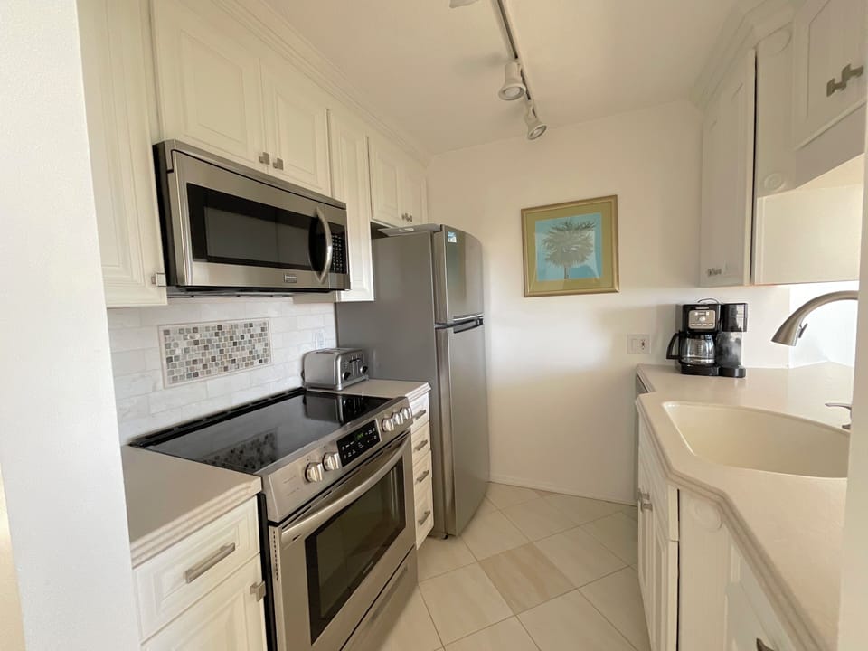 Kitchen all super clean with stainless appliances
