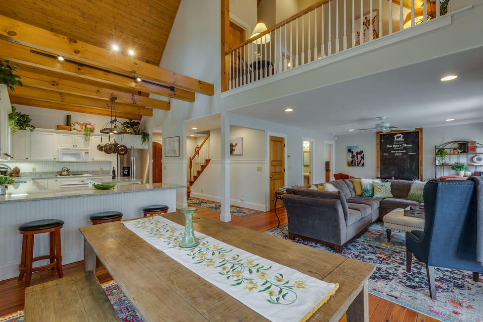 The dining area features a farmhouse table and additional seating at the bar.