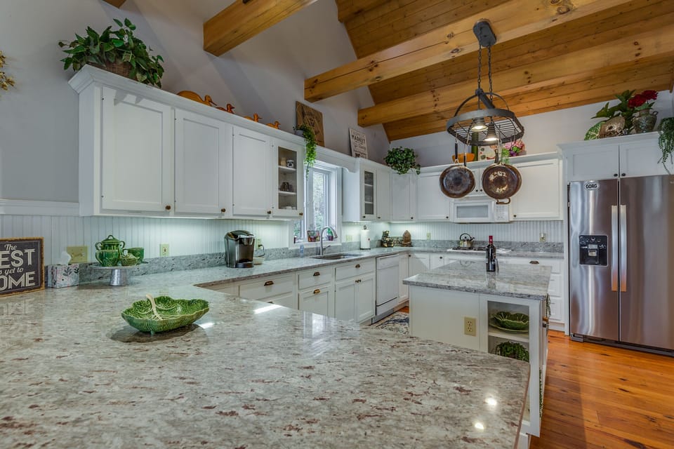 The open kitchen has loads of granite counter space.