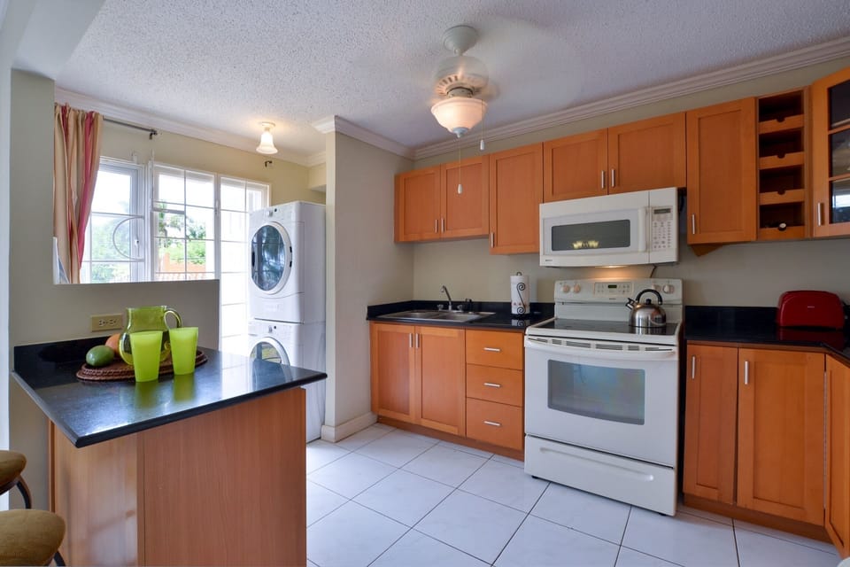 Kitchen Has Rear Door that Leads to the Backyard