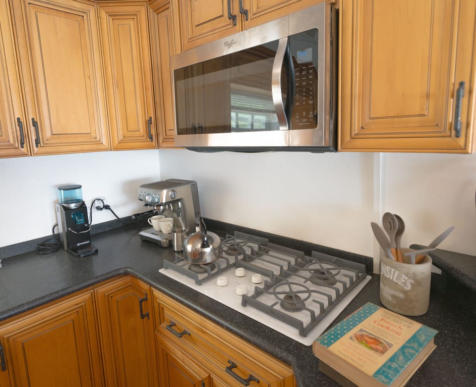 Microwave, coffee grinder, cooking utensils and cook books at your disposal