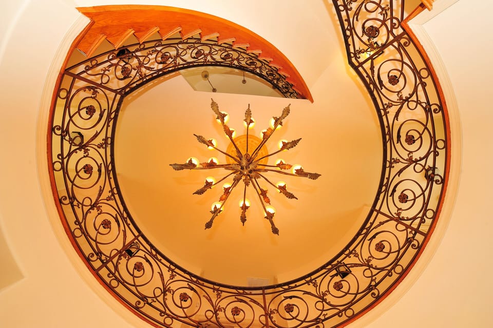 Spectacular customer spiral staircase and chandelier.