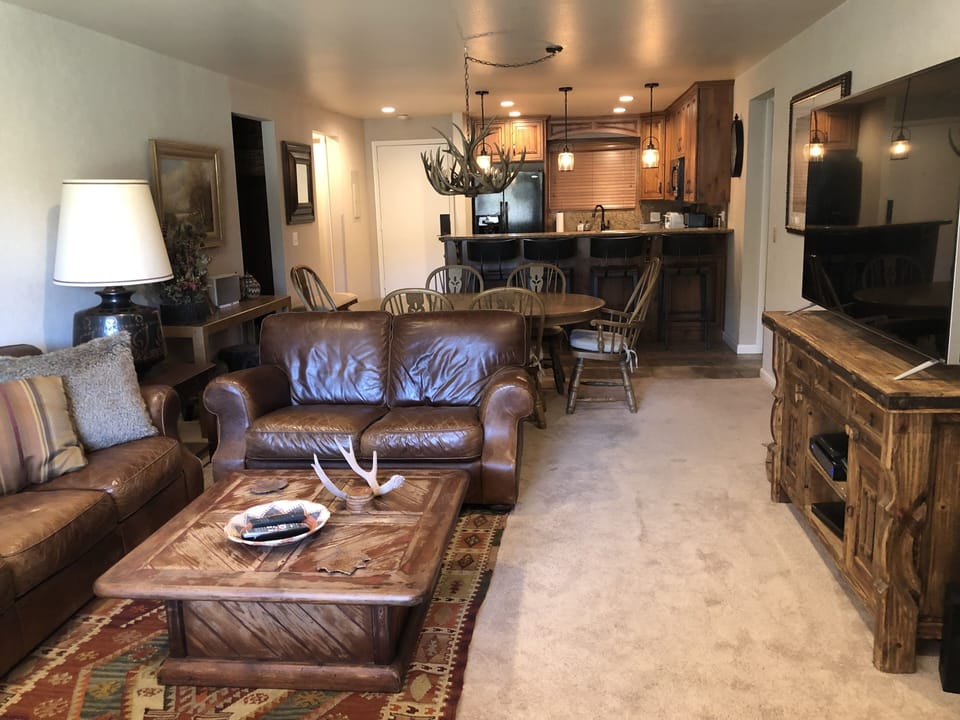 The living room has leather couches, fireplace, 65" 4K TV, DVD, Wifi & Sonos