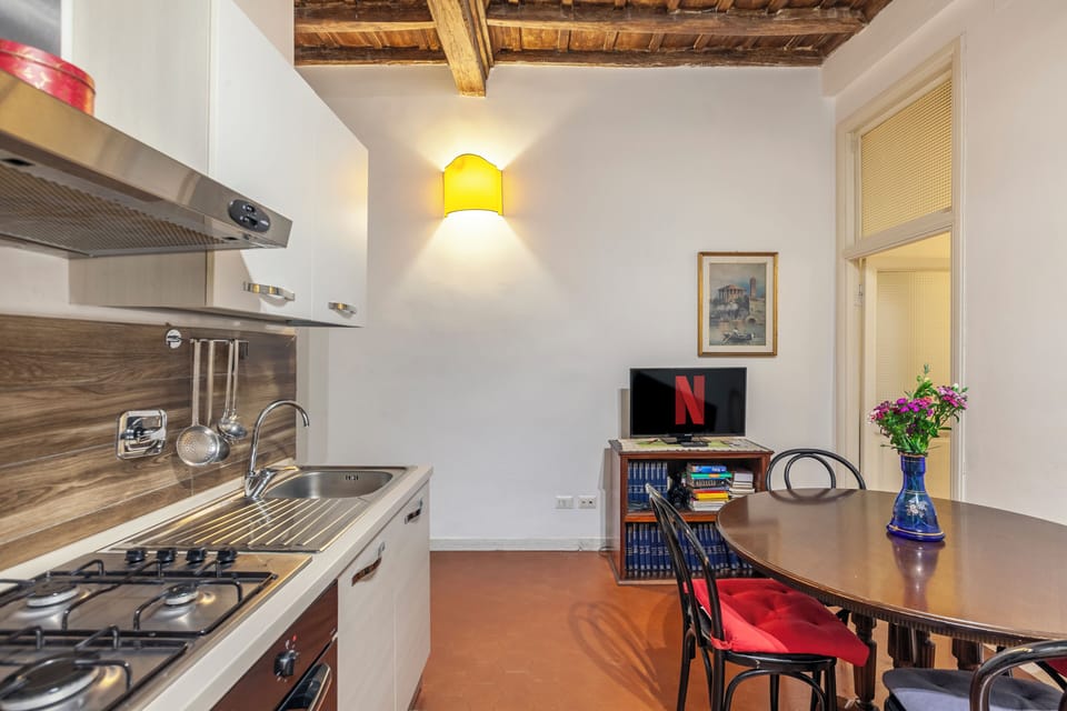 Fully equipped kitchen and living–dining area.