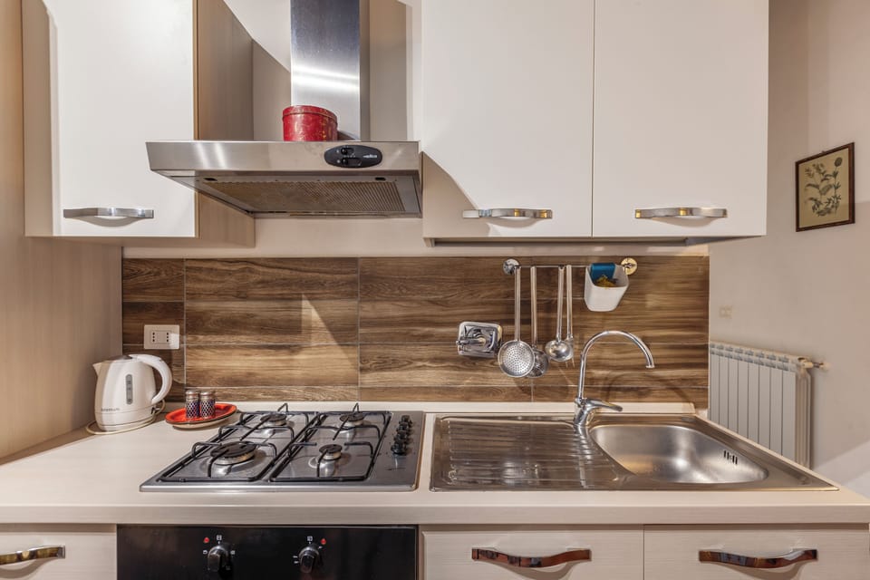 Fully equipped kitchen and living–dining area.