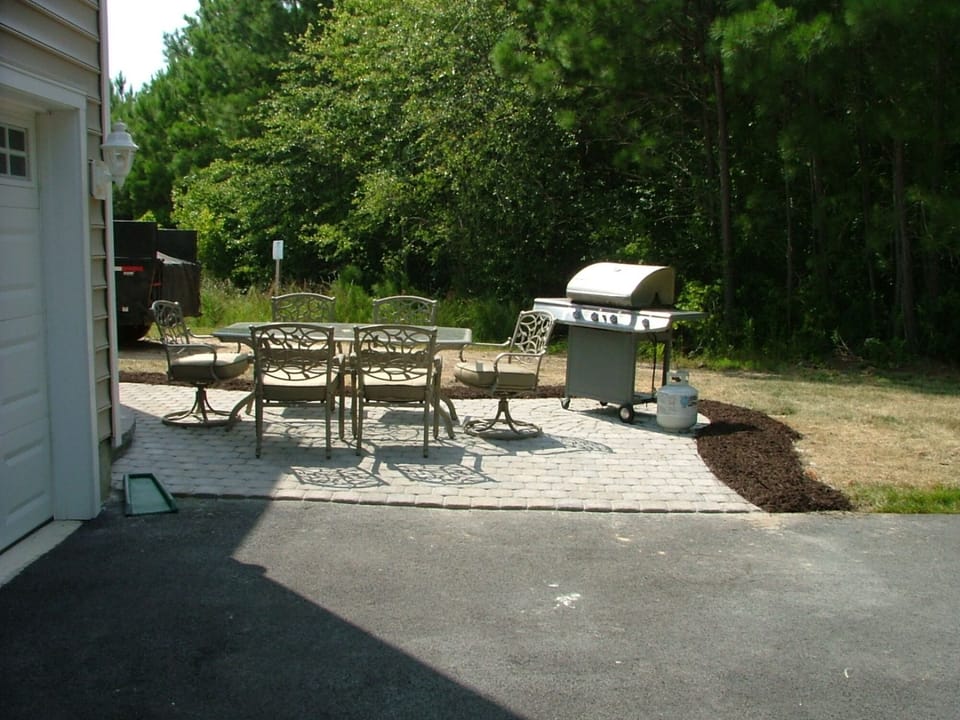 private wooded backyard with patio