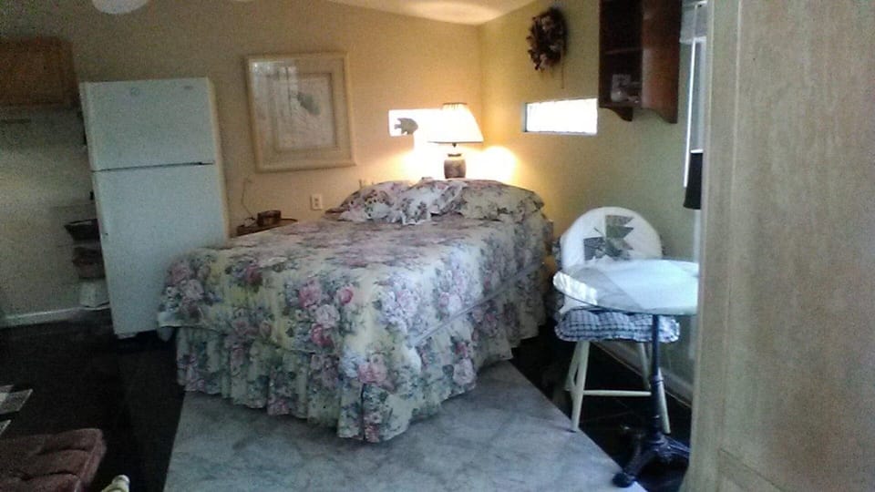 double bed with small dining table for two