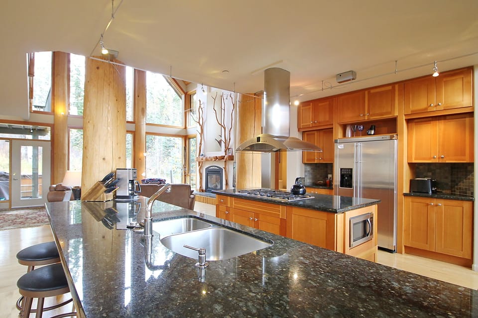 Gourmet kitchen located in center of house open to front and back living rooms.