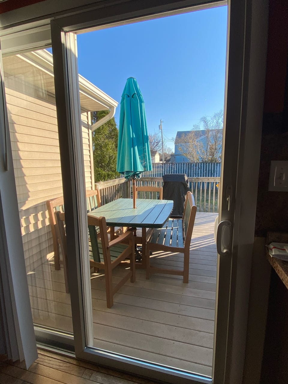 Outside seating near grill with steps going down to yard 