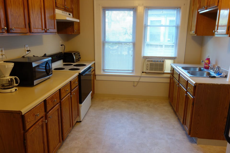 kitchen with microwave, toaster oven, stove and refrigerator.