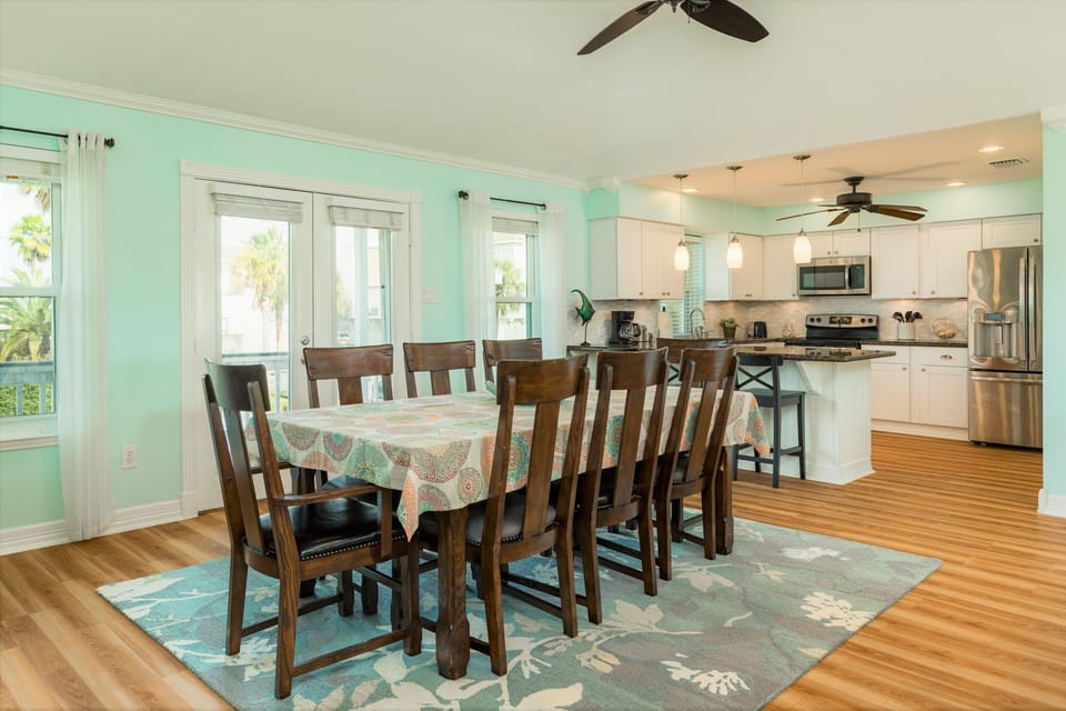 The dining table w/ seating for 8 plus 3 additional seats at the breakfast bar.