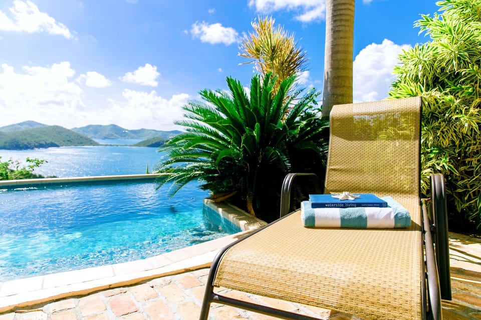 Brick patio seating area overlooking pool and Hurricane Hole