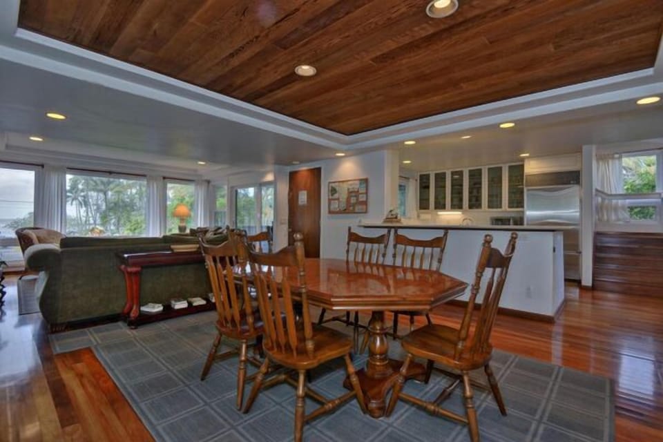 Dining room with kitchen in back and living room to the left.  Newer house.