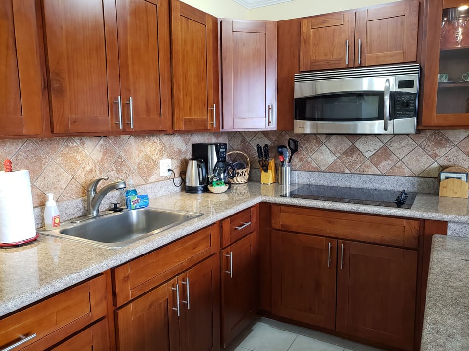 Renovated kitchen with cherry wood cabinets and granite countertops