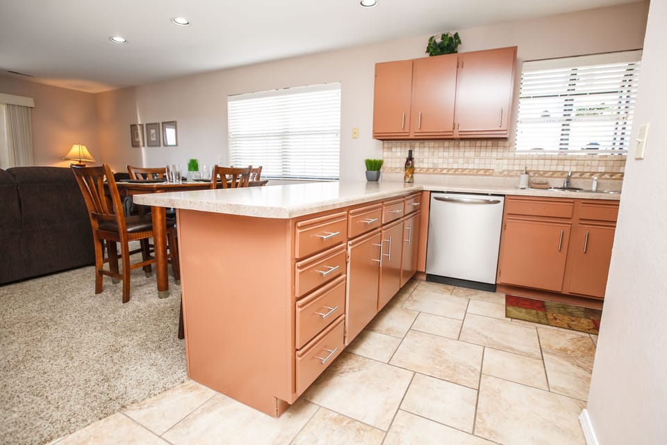 Kitchen w/ microwave, stove, fridge with ice maker, & dishwasher with detergent