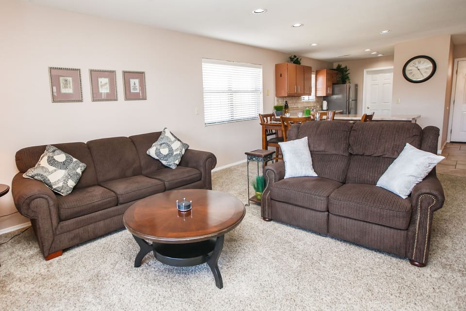Living room with queen sofa sleeper, dual reclining loveseat & TV w/ DVD player