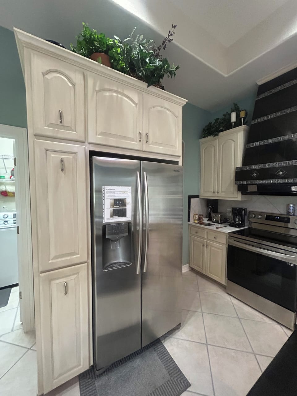 Kitchen   storage and refrigerator with ice and water dispenser, stove 