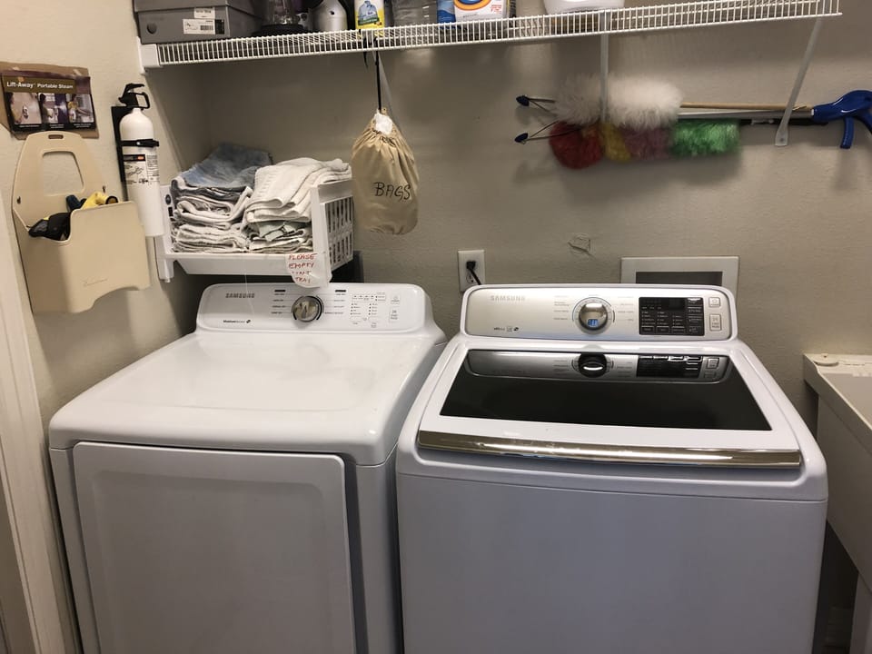 Laundry room, with new Samsung appliances with laundry and cleaning supplies