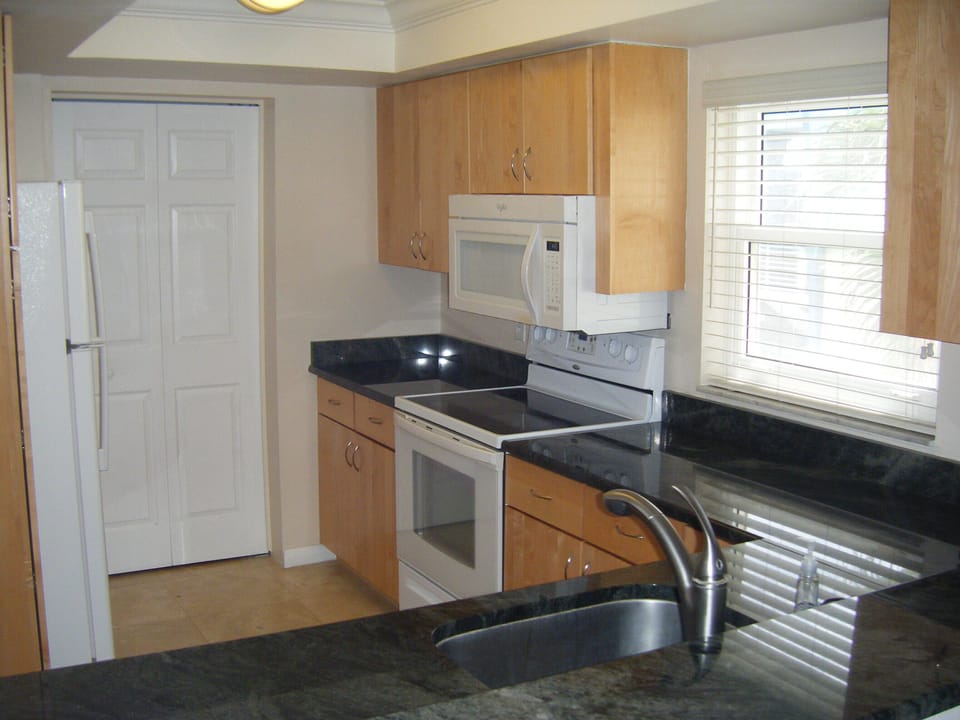Large modern kitchen with window for open feel.