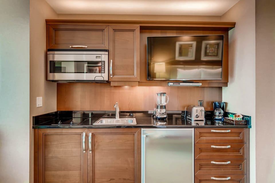 Kitchen area w/cook top, microwave, refrigerator, coffee maker, blender, etc.