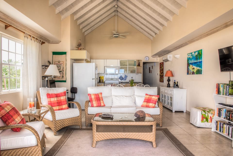 Living room with ample seating. 2 AC, 2 fans, windows, desk w/ monitor & printer