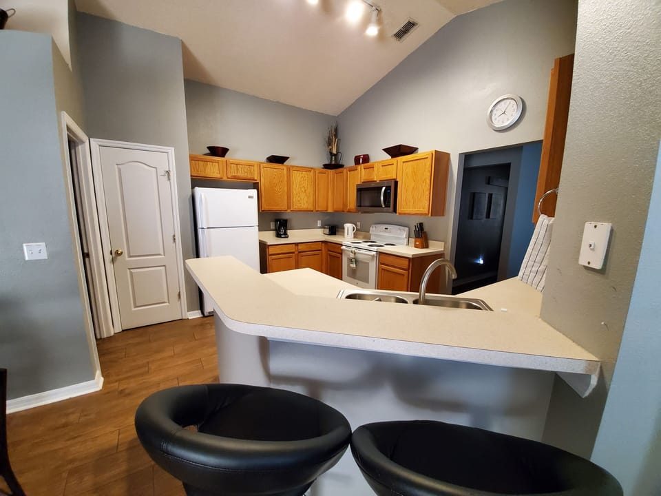 Kitchen with fridge, microwave, stove and dishwasher. 