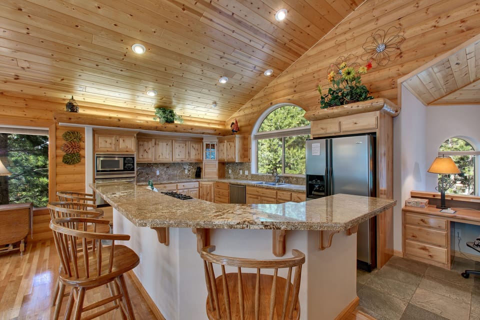 Fully equipped kitchen bathed in granite stone and quartz tile flooring
