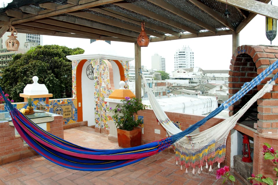 Rooftop retreat with handcrafted tile art and relaxing hammocks 
A serene space.