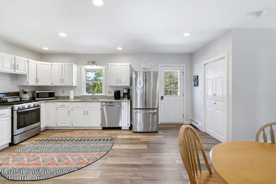 Kitchen opens to back deck with gas grill