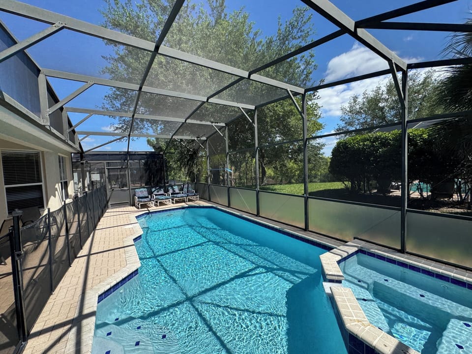 South-facing, fully-screened pool backs to Reedy Lake for privacy.