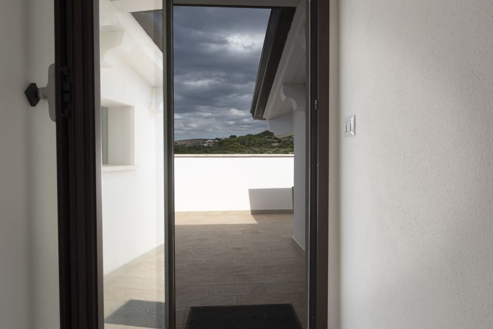 Upper doorway to second large balcony views of mountains and sea