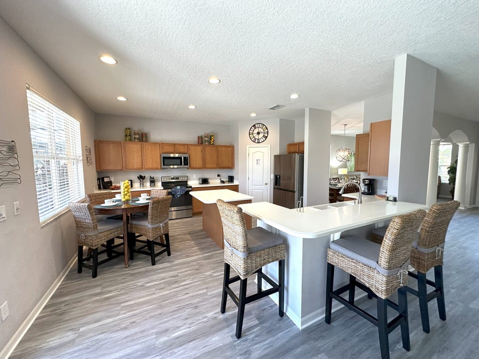 Open plan kitchen with centre island and new stainless steel appliances