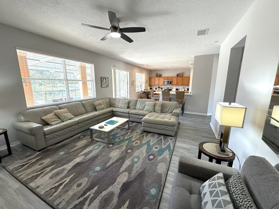 Family room with luxurious leather suite and open plan kitchen/breakfast area