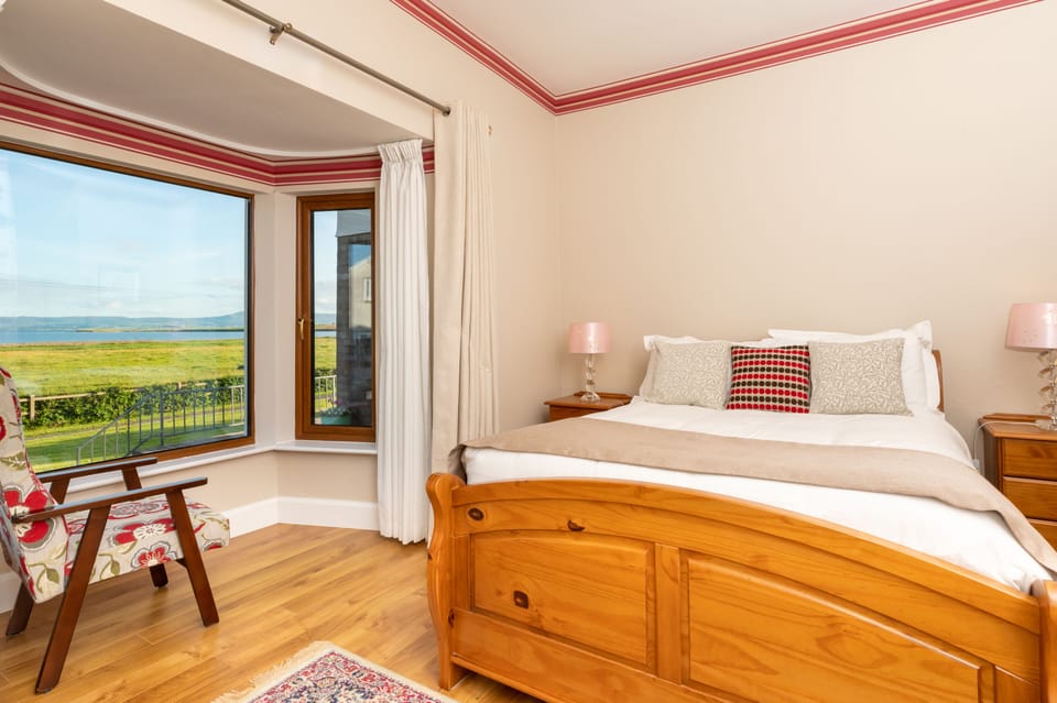 Bedroom One with double bed, lockers, wardrobe and arm chair.