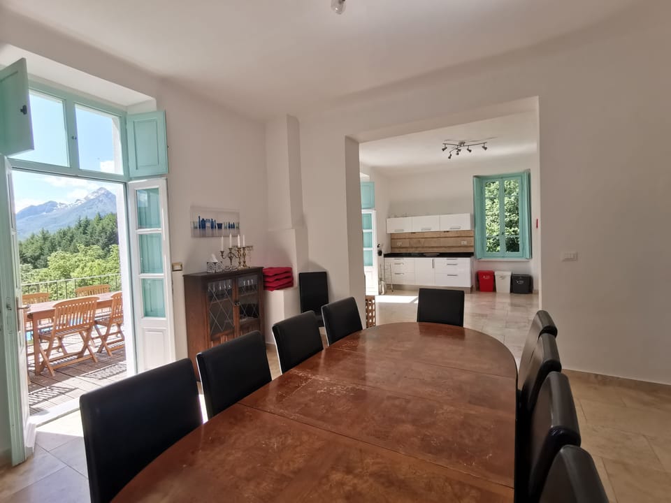 Dining room leading to the kitchen and out to the deck