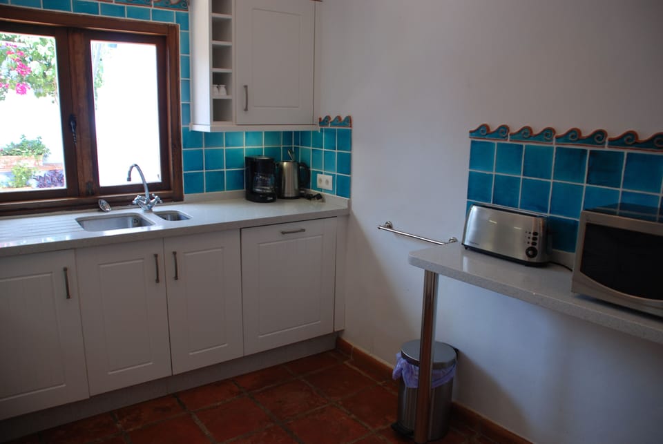 Fully fitted kitchen with window onto patio