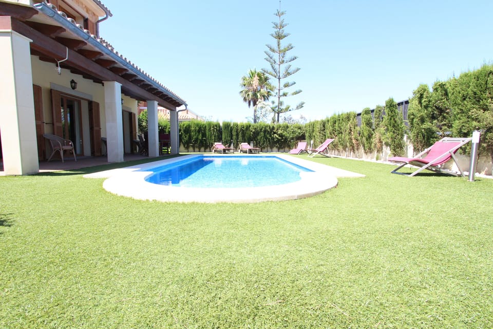 Swimming pool area with sun beds.