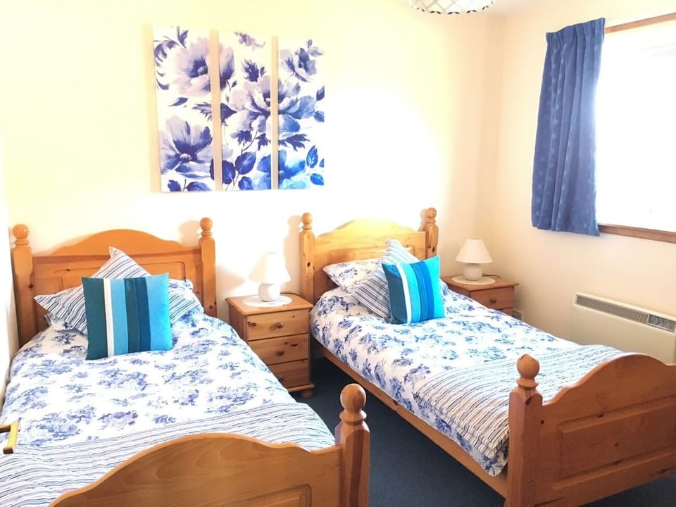 Twin Bedroom with ample storage and electric panel heater.