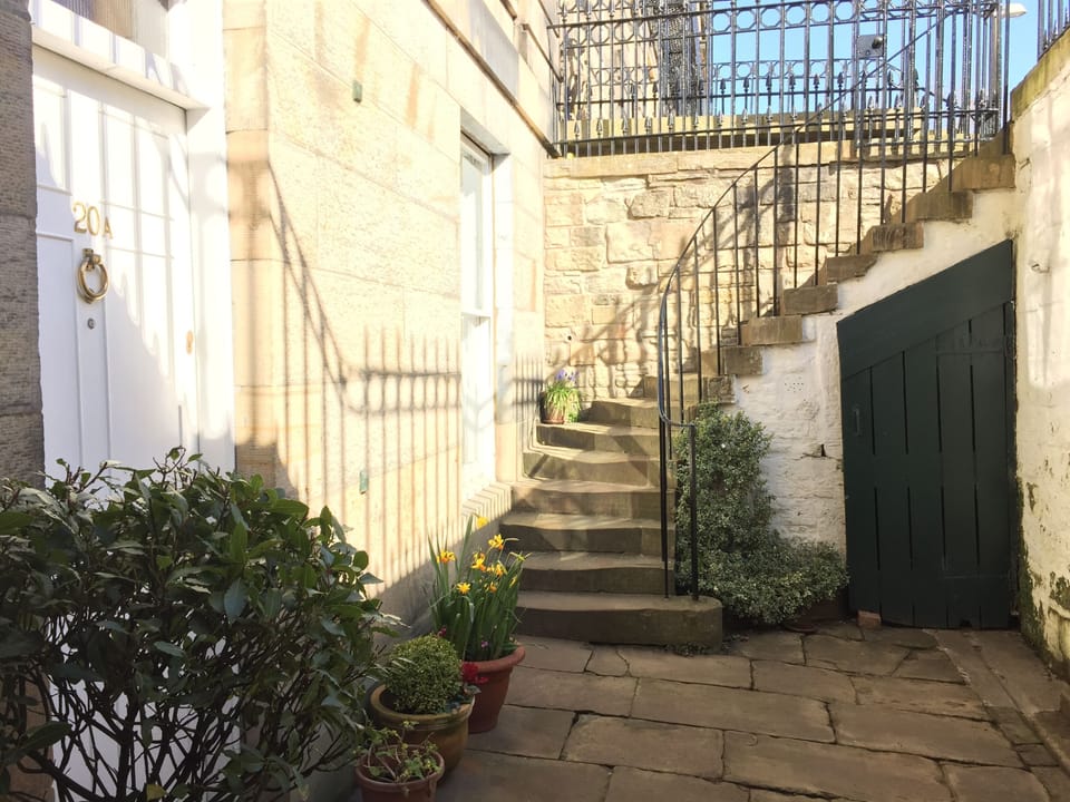 Entrance down steps to private courtyard and front door