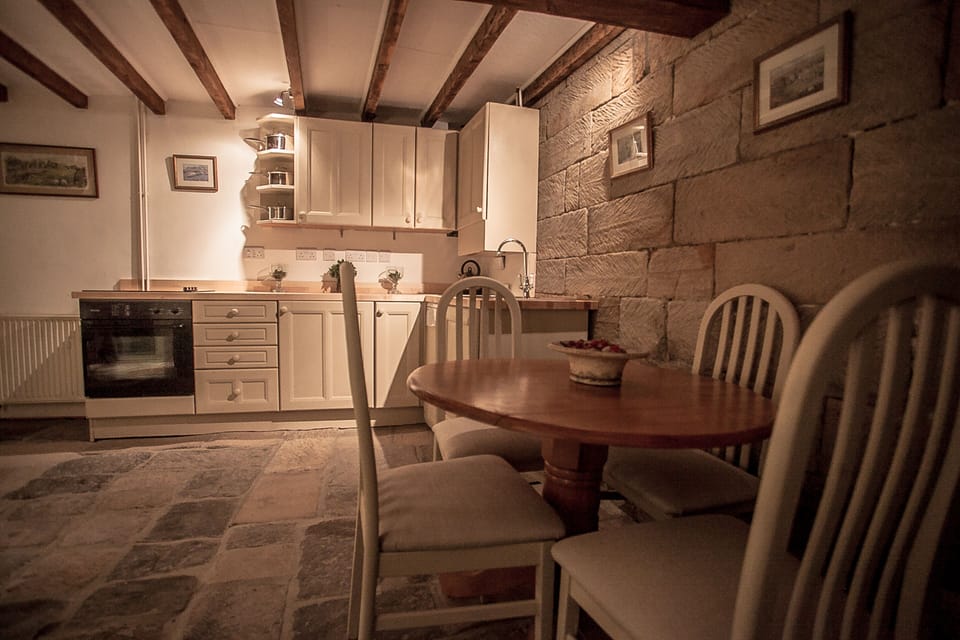 Dining area and fully equipped kitchen, with cooker, fridge and dishwasher