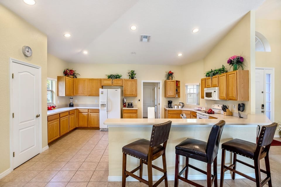 Breakfast bar overlooking enormous, well stocked kitchen