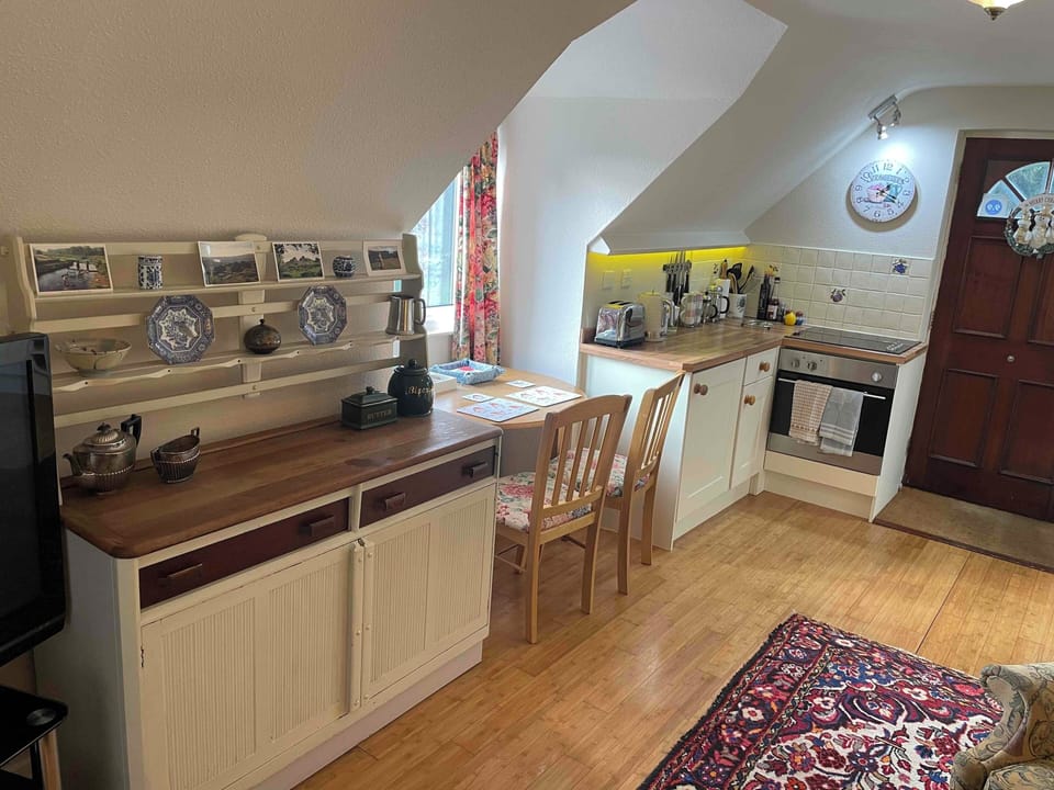 Dining area and side dresser with cutlery, plates, mugs, bowls