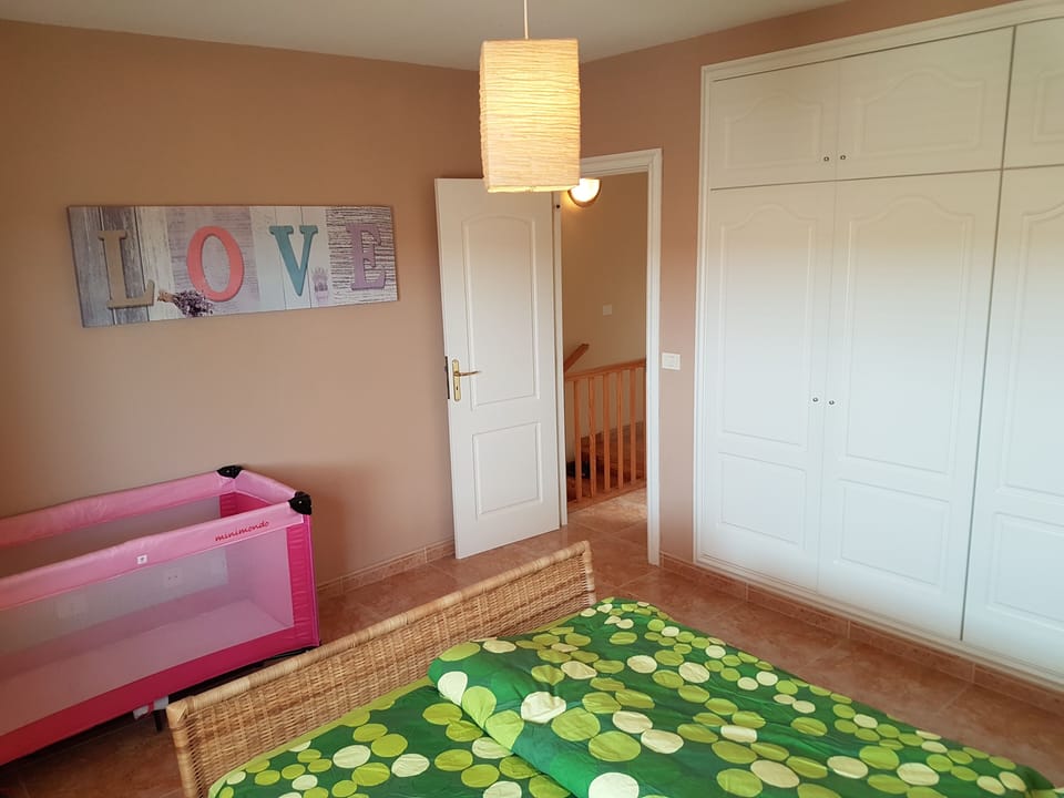 Bedroom with fitted wardrobe and cot