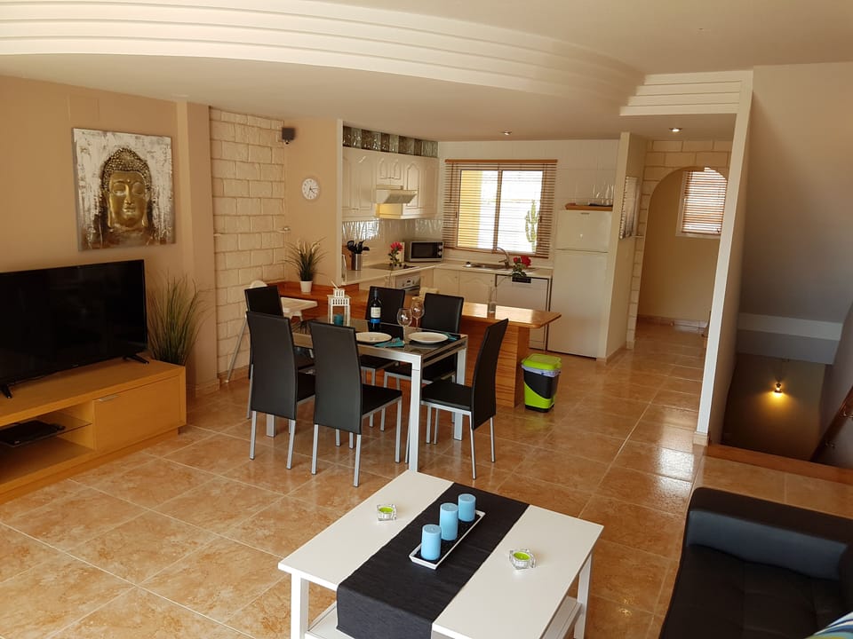 Bright and modern living room with flat screen TV, leather sofa, Internet