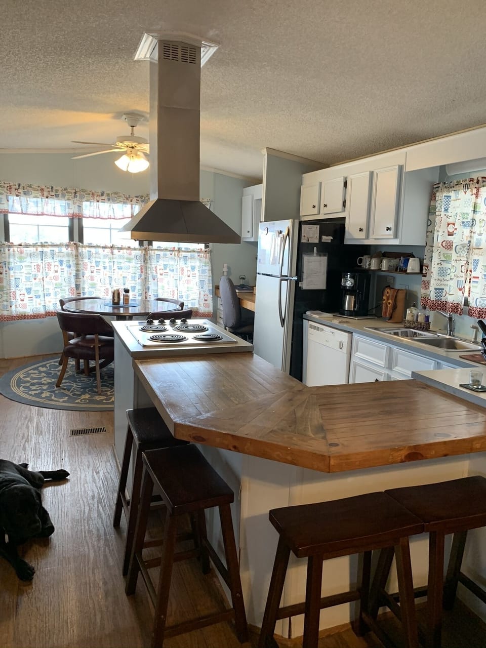 Plenty counter space, four barstools for extra seating.