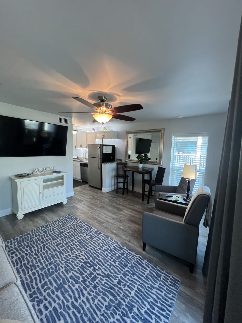 Living room w/ view of kitchen.