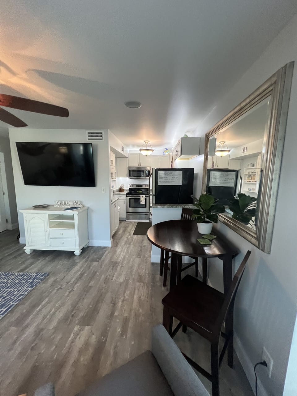 View of breakfast nook, kitchen & living room smart tv.