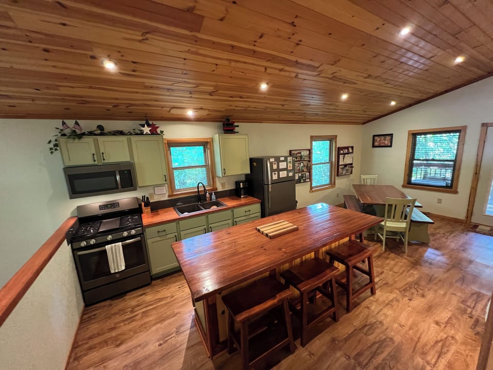 Kitchen area with large island has seating for 4.  Custom wood counter tops.