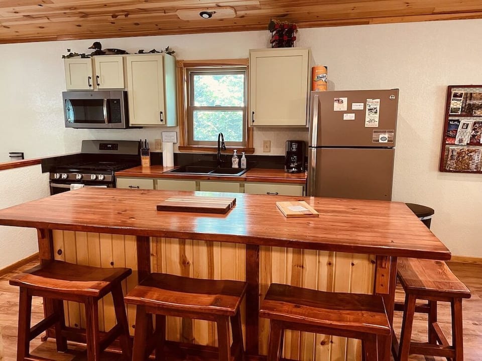 Kitchen area with large island has seating for 4.  Custom wood counter tops.